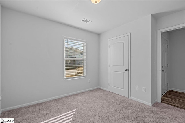 unfurnished bedroom featuring light colored carpet