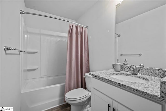 full bathroom featuring vanity, hardwood / wood-style flooring, toilet, and shower / bath combo with shower curtain