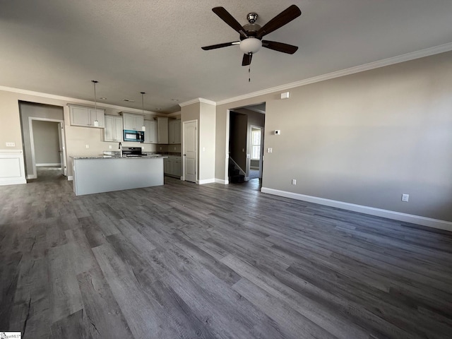 kitchen featuring hanging light fixtures, crown molding, a kitchen island, and dark hardwood / wood-style floors