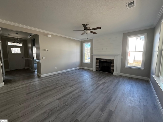 unfurnished living room featuring dark wood-type flooring, a textured ceiling, and a wealth of natural light