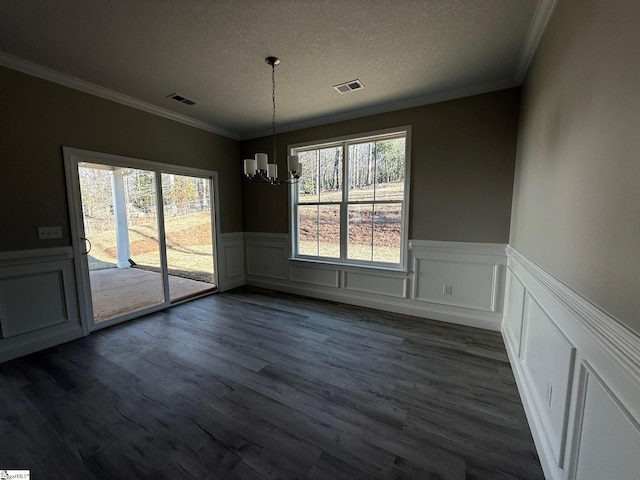 unfurnished dining area with a healthy amount of sunlight, dark hardwood / wood-style floors, and a textured ceiling