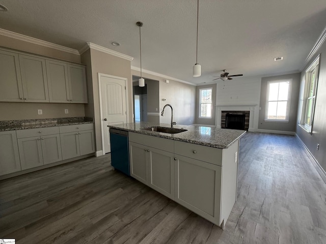 kitchen with sink, ornamental molding, gray cabinets, dishwashing machine, and light stone countertops