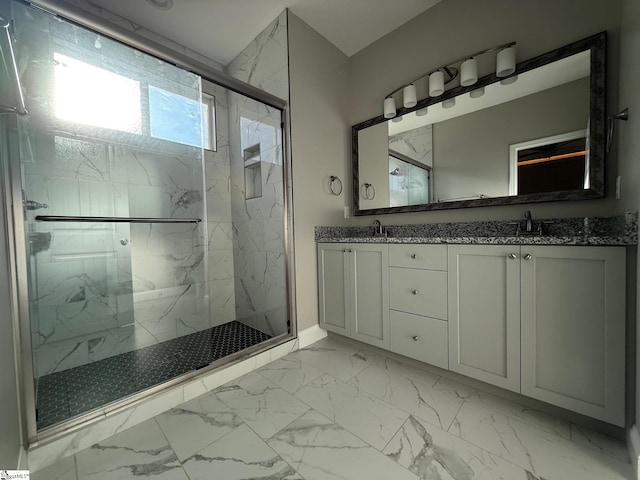 bathroom with a shower with door and vanity