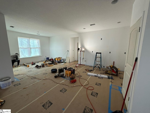 miscellaneous room with a textured ceiling