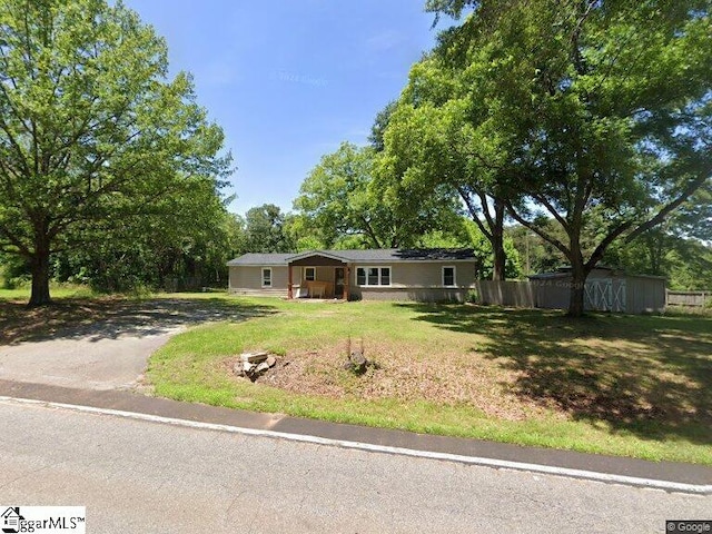 ranch-style home with a front lawn