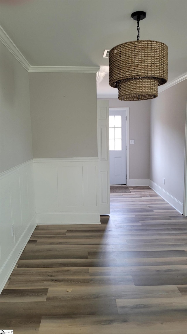 unfurnished room with crown molding and dark wood-type flooring