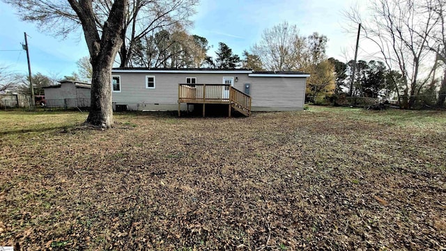 back of property featuring cooling unit, a yard, and a wooden deck