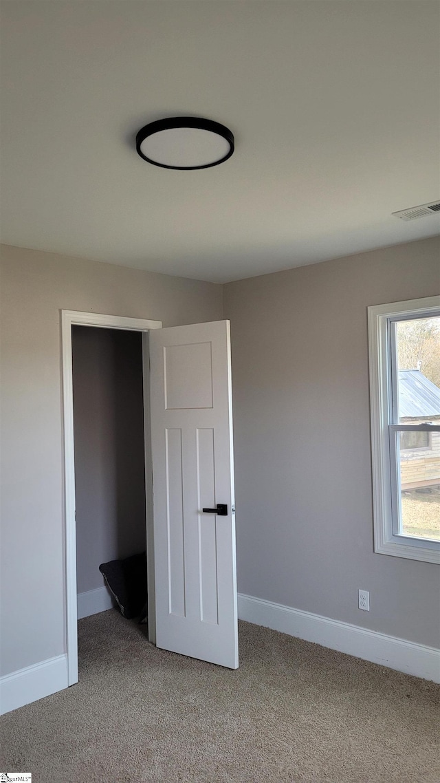 unfurnished bedroom featuring light colored carpet