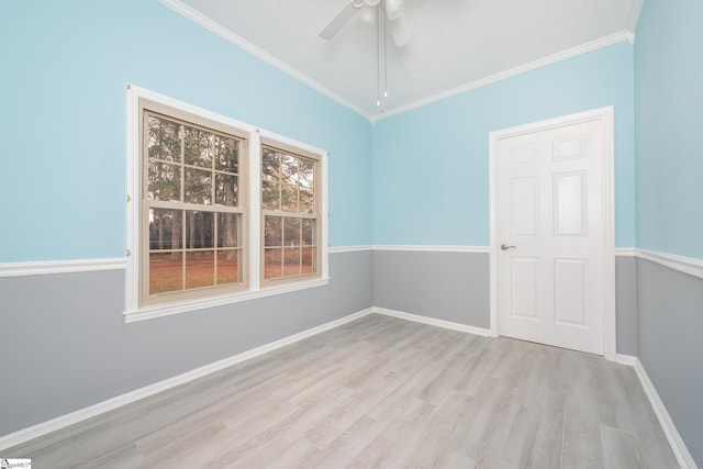 empty room featuring ceiling fan, light wood-type flooring, and ornamental molding