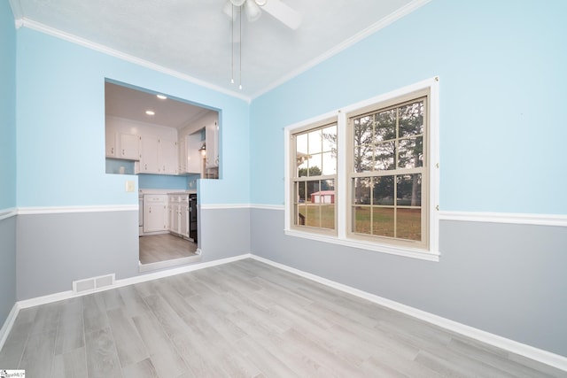 spare room with ceiling fan, light hardwood / wood-style floors, and ornamental molding