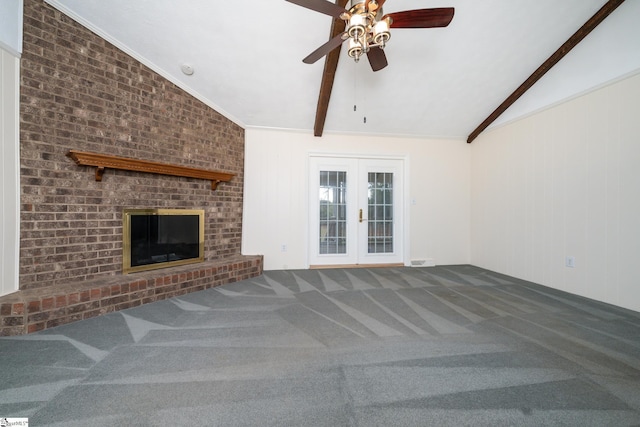 unfurnished living room featuring carpet, french doors, ornamental molding, ceiling fan, and vaulted ceiling with beams