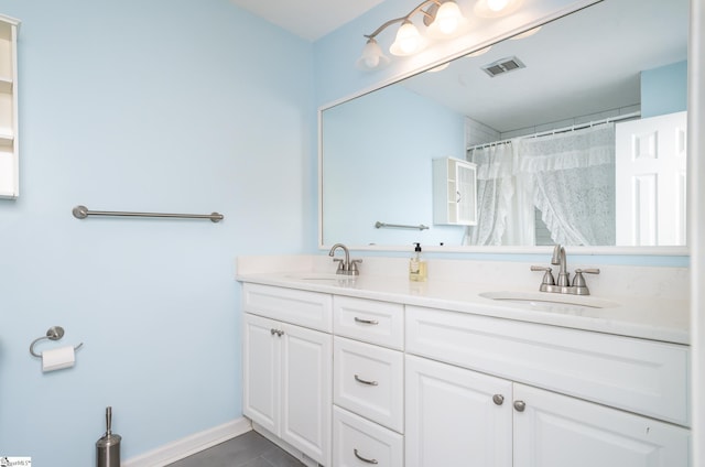 bathroom featuring a shower with curtain, vanity, and tile patterned flooring