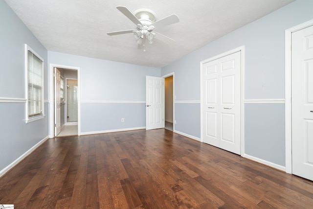 unfurnished bedroom featuring ceiling fan, dark hardwood / wood-style flooring, and a textured ceiling