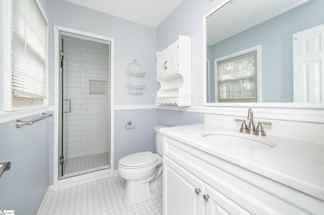 bathroom with toilet, a shower with shower door, and a healthy amount of sunlight