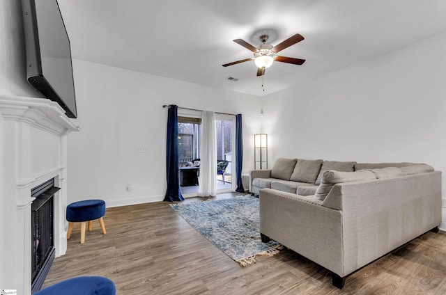 living room with ceiling fan and wood-type flooring