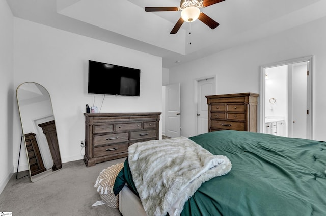 carpeted bedroom featuring ensuite bathroom and ceiling fan