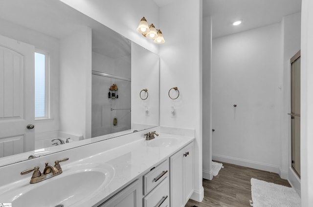 bathroom with vanity, wood-type flooring, and shower with separate bathtub