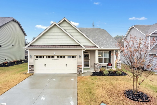 view of front of house featuring a front lawn, covered porch, and a garage