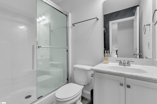 bathroom featuring walk in shower, vanity, and toilet