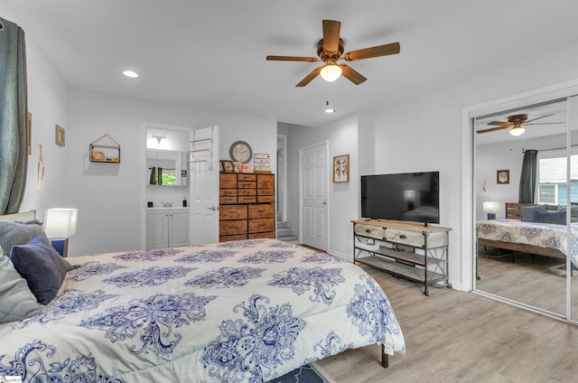 bedroom with ceiling fan, light hardwood / wood-style floors, and connected bathroom