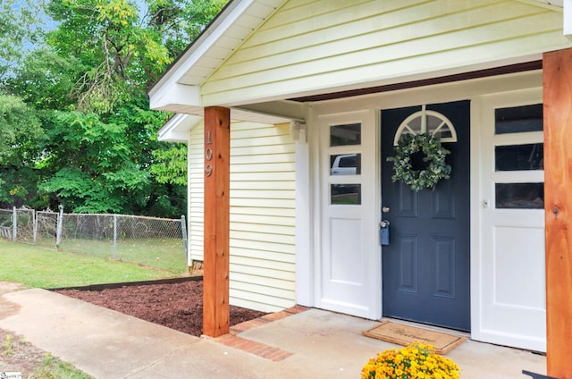 entrance to property with a lawn