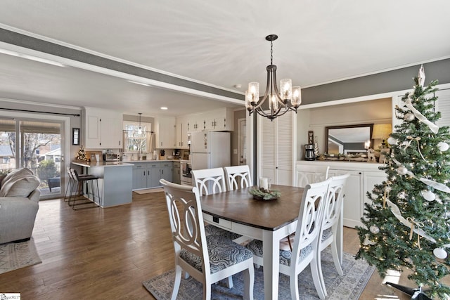 dining space featuring dark hardwood / wood-style flooring and a notable chandelier