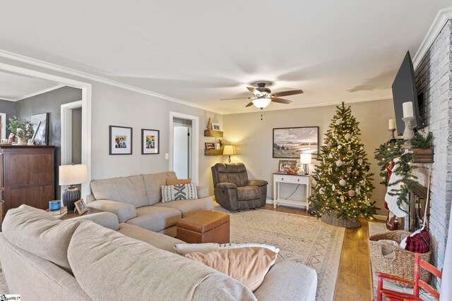 living room featuring a fireplace, ceiling fan, hardwood / wood-style floors, and ornamental molding