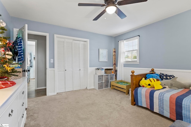 carpeted bedroom with a closet and ceiling fan