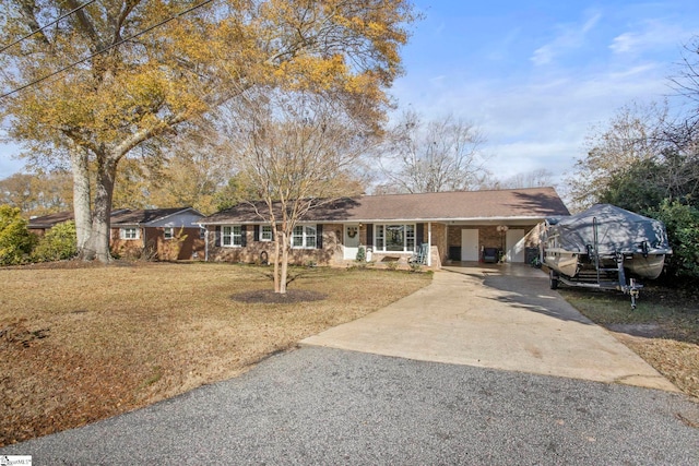 ranch-style home with a front lawn and a carport