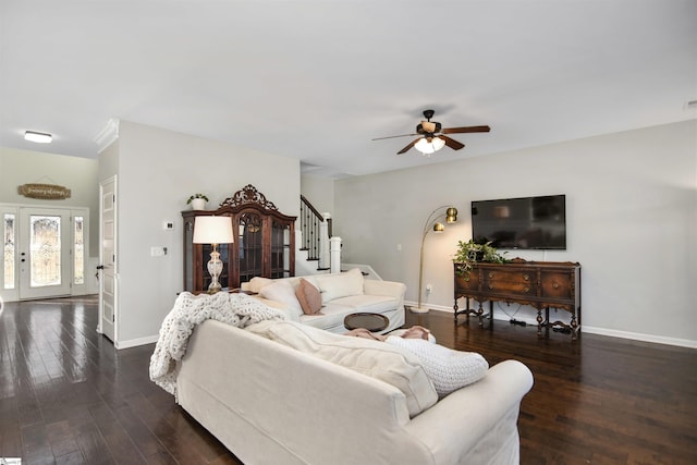 living room featuring ceiling fan and dark hardwood / wood-style flooring