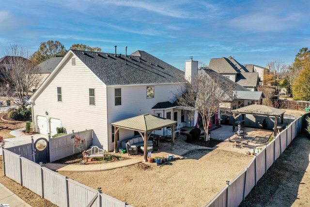 rear view of house featuring a gazebo and a patio area