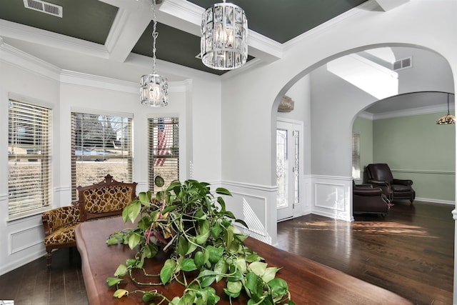 dining room with hardwood / wood-style floors, an inviting chandelier, ornamental molding, and coffered ceiling