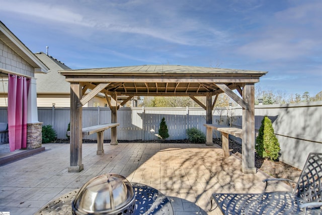 view of patio / terrace featuring a gazebo and a fire pit