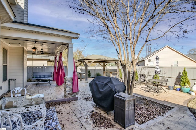 view of patio / terrace featuring a gazebo, area for grilling, and ceiling fan