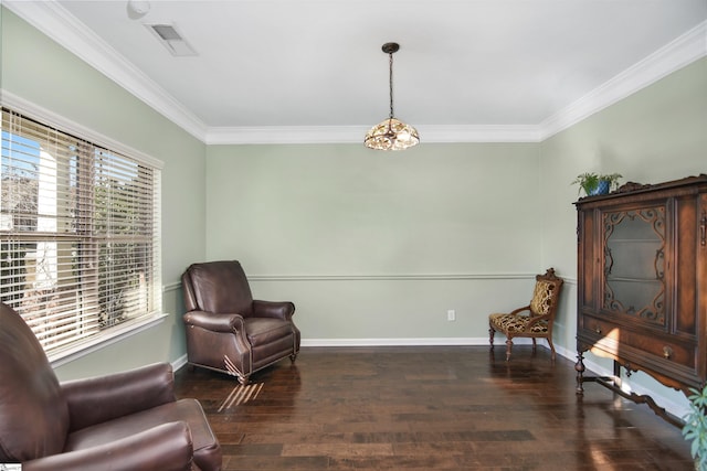 living area featuring dark hardwood / wood-style flooring, a wealth of natural light, and ornamental molding