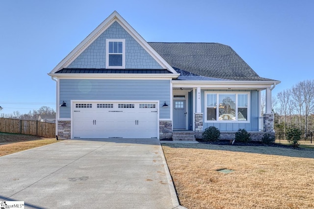 craftsman-style house featuring a garage and a front lawn