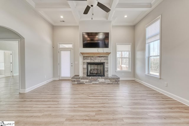 unfurnished living room with light wood-type flooring, ceiling fan, and coffered ceiling