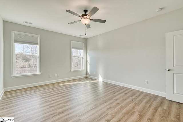 unfurnished room with ceiling fan, plenty of natural light, and light wood-type flooring