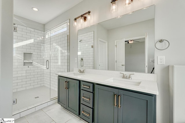 bathroom with tile patterned floors, ceiling fan, an enclosed shower, and vanity