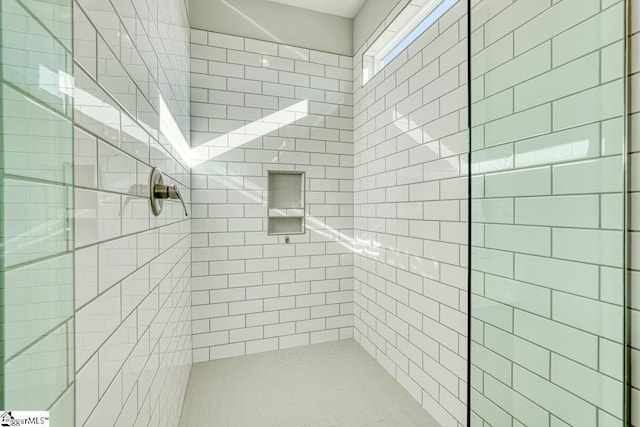 bathroom with a tile shower