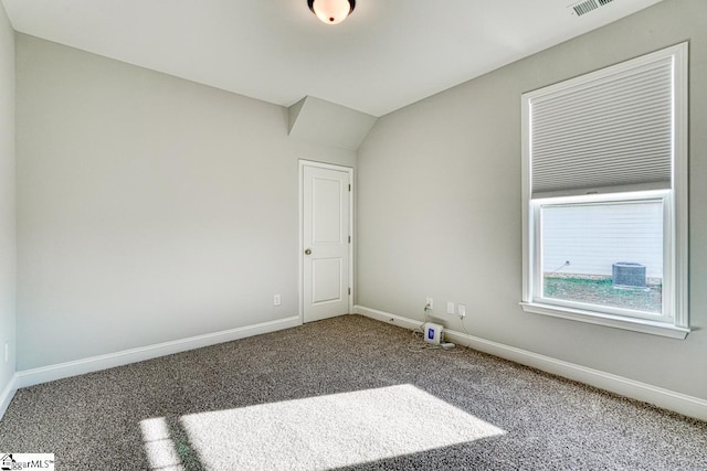 unfurnished room featuring carpet and lofted ceiling