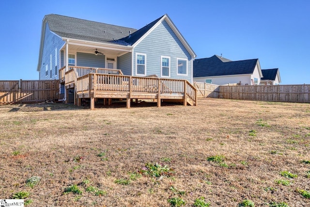 rear view of property featuring a deck and ceiling fan