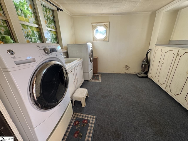 laundry area with crown molding, washer and dryer, cabinets, and dark carpet