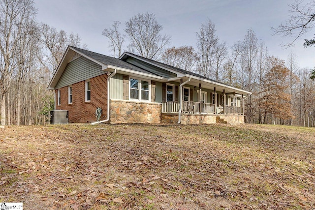 view of front of home featuring central AC unit and a porch