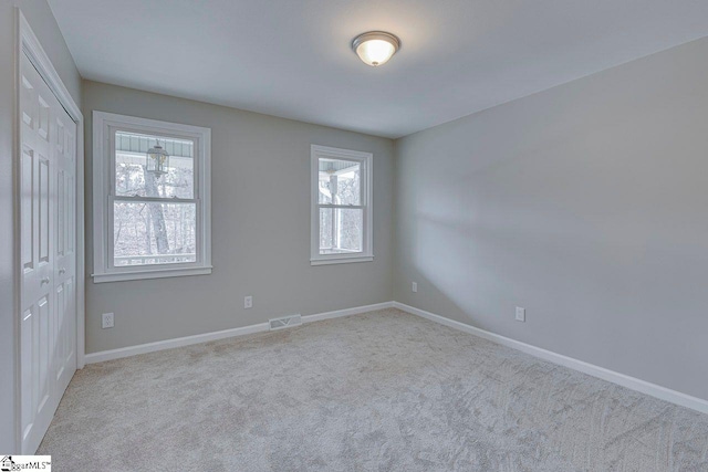 carpeted spare room with plenty of natural light