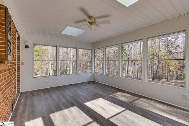 unfurnished sunroom with a skylight, a wealth of natural light, and ceiling fan