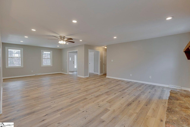 unfurnished living room featuring light wood-type flooring and ceiling fan