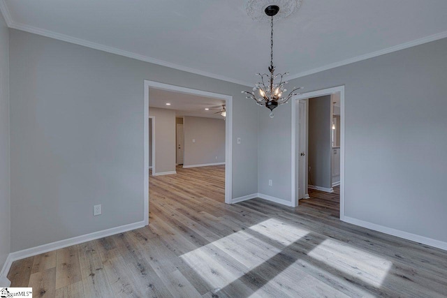 interior space featuring light hardwood / wood-style flooring, a notable chandelier, and ornamental molding