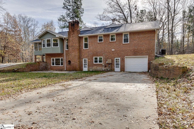 rear view of property featuring a garage