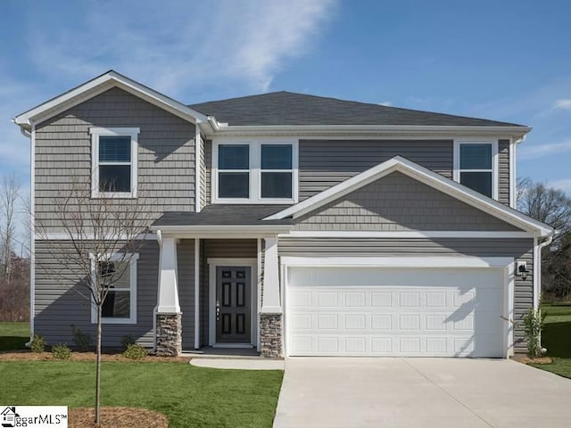 craftsman house with a front yard and a garage